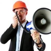 Businessman in helmet shouting with megaphone over white background