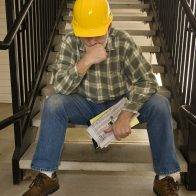 Construction worker contemplating his next move after being laid off.