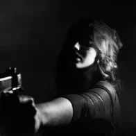 Woman holding a gun in the workplace.