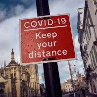 CAMBRIDGE, ENGLAND - NOVEMBER 10: A sign indicates keeping a safe distance on November 10, 2020 in Cambridge, England. England entered a second national coronavirus lockdown on 5th November. People are still permitted to exercise with one other person, takeaway food is permitted but bars and restaurants are shut for sit-in service. Schools will remain open but people are being advised to work from home where possible and only undertake necessary travel. All non-essential shops are closed with supermarkets and builders' merchants remaining open. (Photo by Gareth Cattermole/Getty Images)