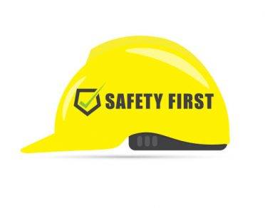 Safety first symbol with yellow helmet on white
