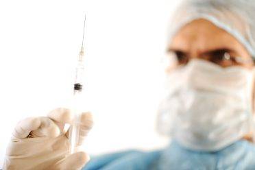 Surgeon holding injection vaccine