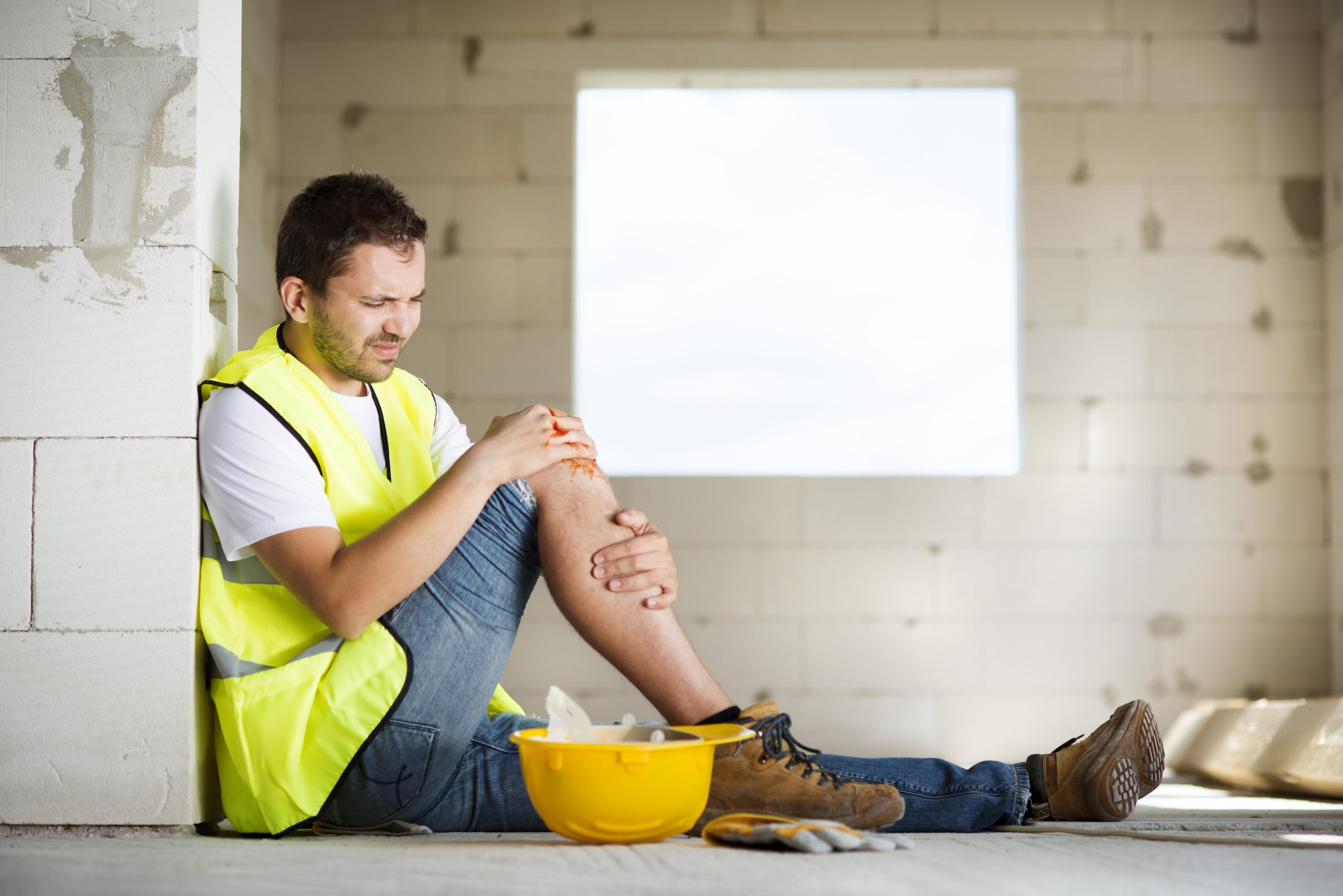 graphicstock-construction-worker-has-an-accident-while-working-on-new-house_H0mkq8Rq-Z-scaled