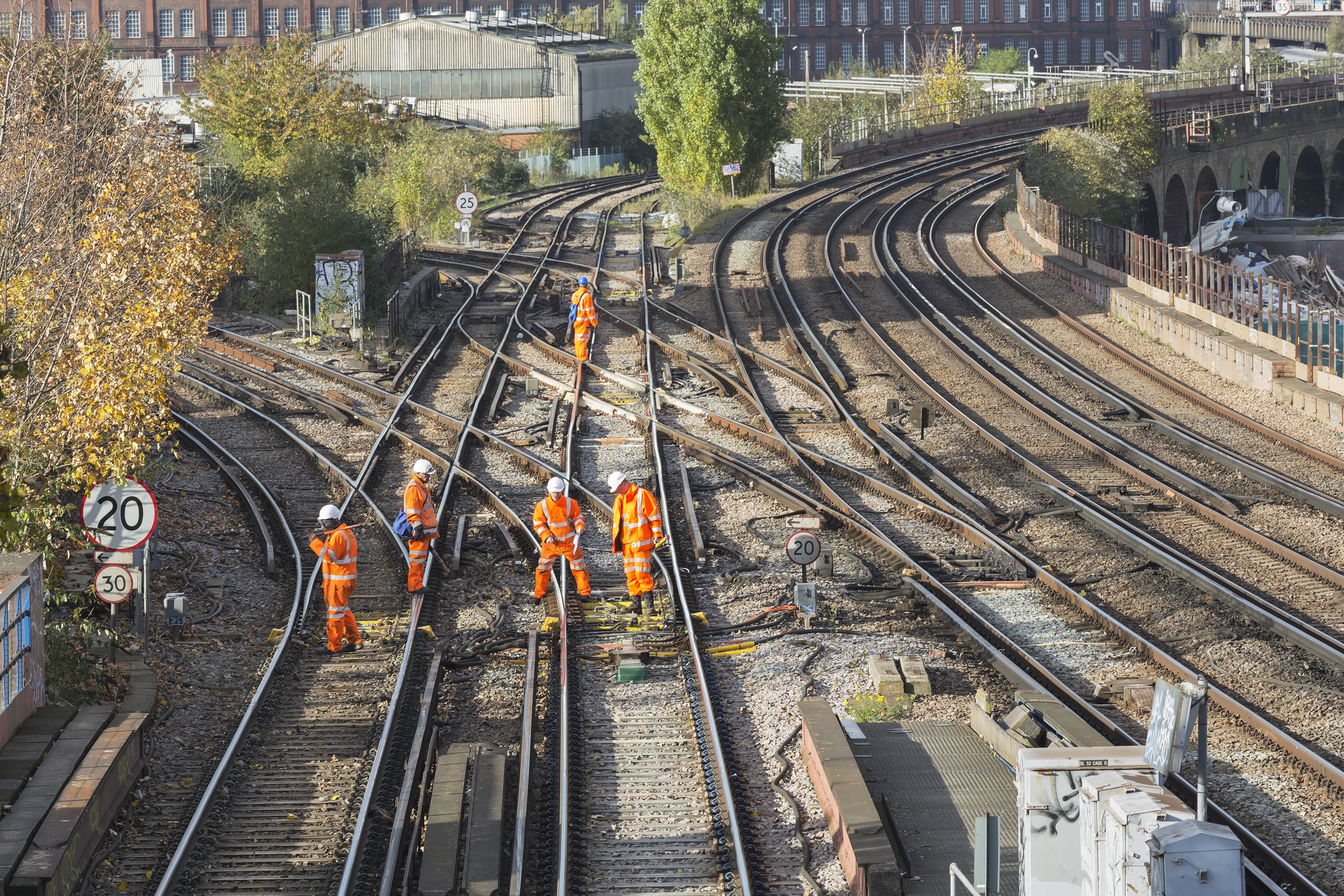 "London, UK - November 5, 2012: A team of rail track maintenance workers inspecting and repairing a railway track during the day in London."